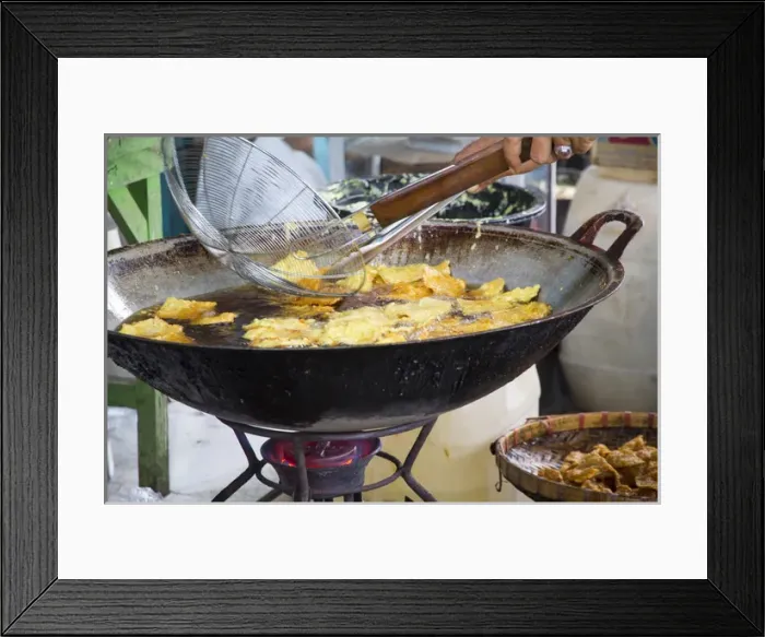 Framed Print : Asia, Indonesia, Bali. Frying Indonesian food called bali bakwan and tofu goreng