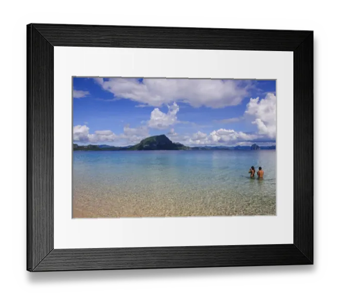 Framed Print : Couple standing in the clear waters of the Bacuit archipelago, Palawan, Philippines