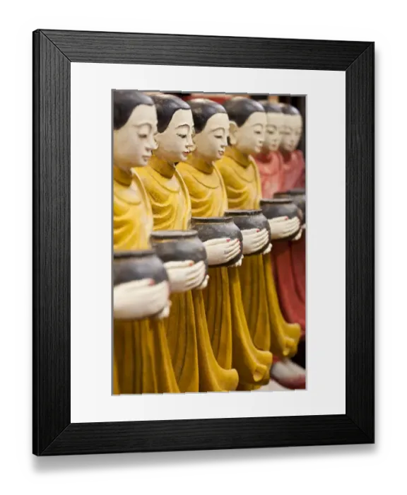 Framed Print : Row of Buddhist monk statues holding alms bowls, Weekend Market, Bangkok, Thailand