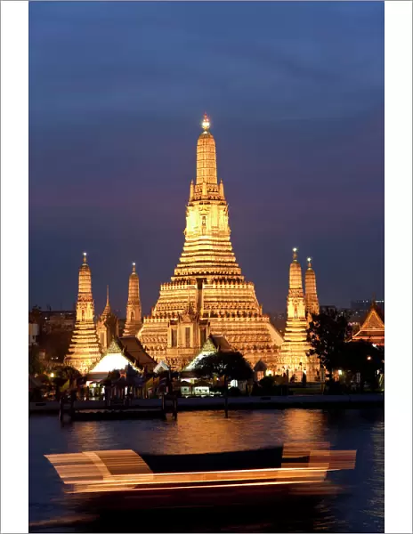 Temple of Dawn (Wat Arun) at dusk with boat on Chao Phraya River, Bangkok, Thailand