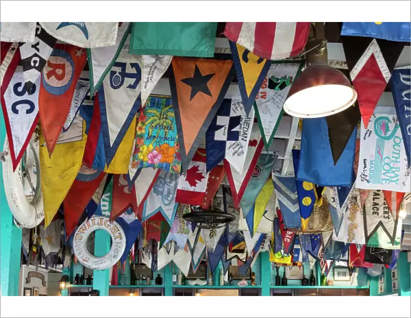 Bahamas, Exuma Island. Flags on ceiling of bar at Yacht Club