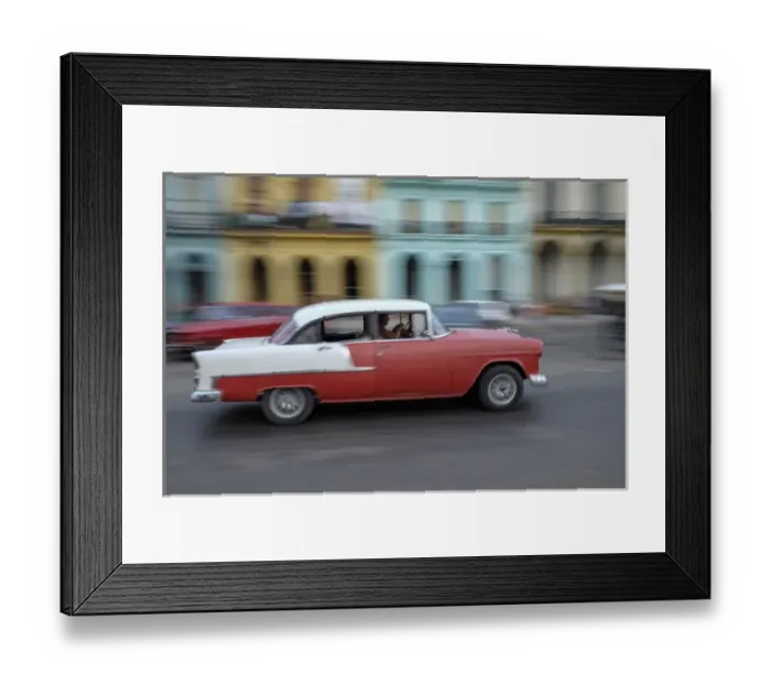 Framed Print : Cuba, Havana. A classic american car zooms along a city street Framed Print : Cuba, Havana. A classic american car zooms along a city street