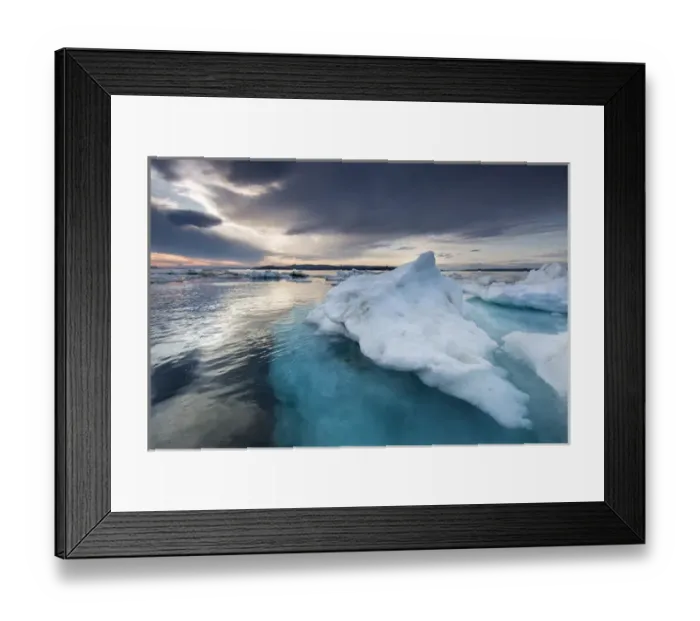 Framed Print : Canada, Nunavut, Territory, Afternoon sun lights storm clouds above melting iceberg Framed Print : Canada, Nunavut, Territory, Afternoon sun lights storm clouds above melting iceberg