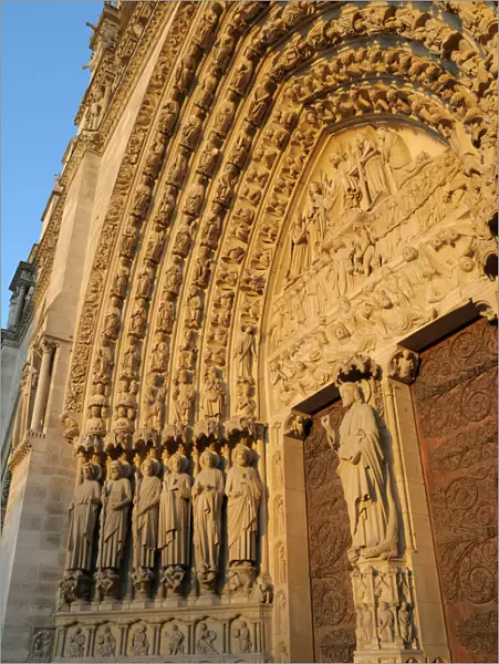 Europe, France, Paris. Door arches with carved saints, Notre Dame Cathedral