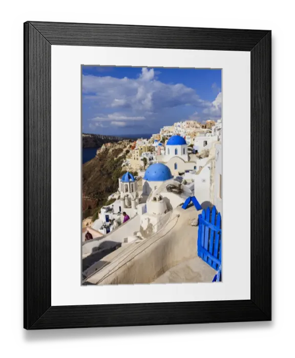 Framed Print : Blue Roofed Churches and homes are everywhere on the Island. Santorini. Greece