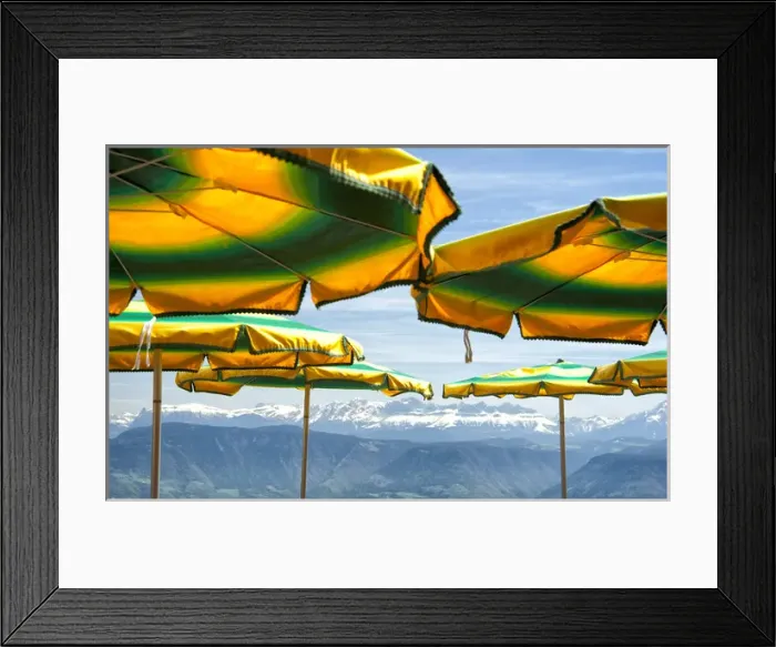 Framed Print : Umbrellas from a mountain top cafe overlooking the alps in Italy Framed Print : Umbrellas from a mountain top cafe overlooking the alps in Italy