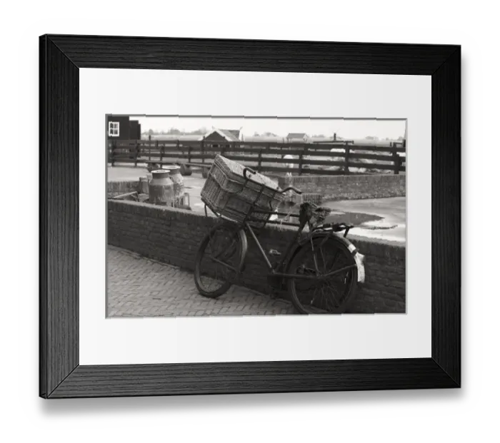 Framed Print : An old fashioned bike with basket leaning again brick wall on an old farm