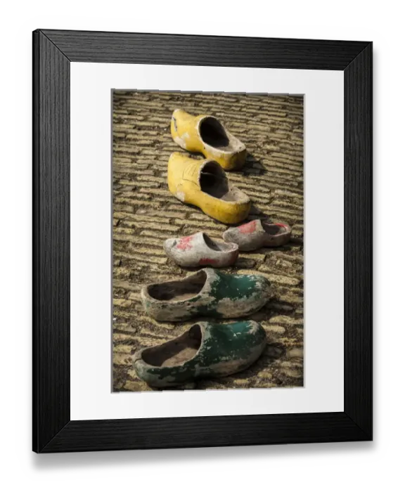 Framed Print : Dutch wooden shoes lined up on a stone path Framed Print : Dutch wooden shoes lined up on a stone path