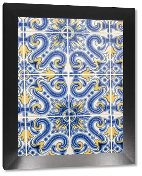 Portugal, Lisbon. Door way with blue and yellow tile work (Azulejos) in the historic