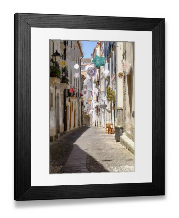 Framed Print : Portugal, Coimbra. Narrow Cobblestone streets in the old section of town, decorated Framed Print : Portugal, Coimbra. Narrow Cobblestone streets in the old section of town, decorated