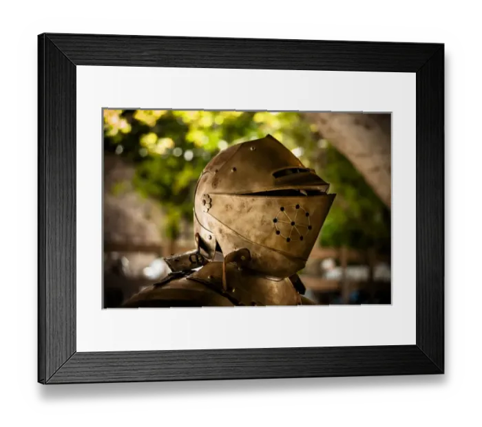 Framed Print : The helmet and shoulder piece of a medieval knights armor