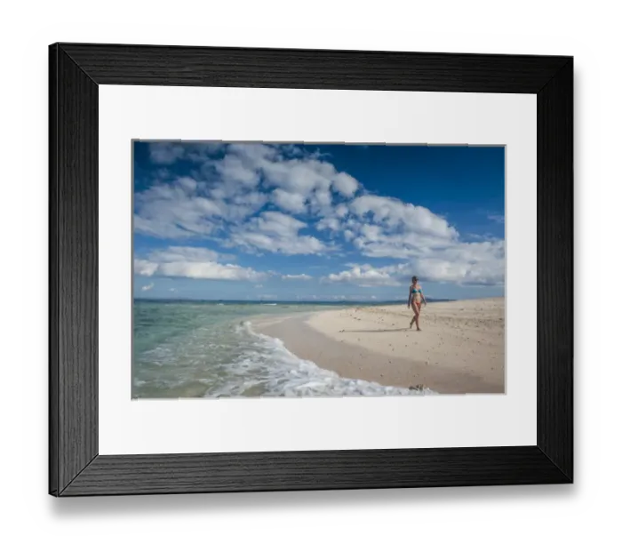 Framed Print : Woman walking along the white sand beach of Beachcomber island, Mamanucas islands