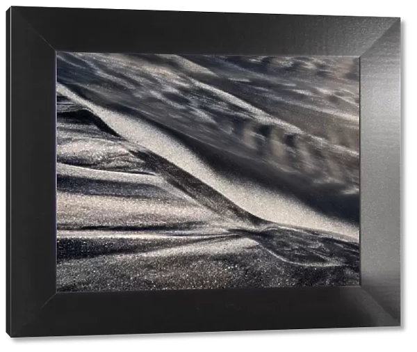 USA, California, Encinitas, Black-and-white abstract of water flowing on beach