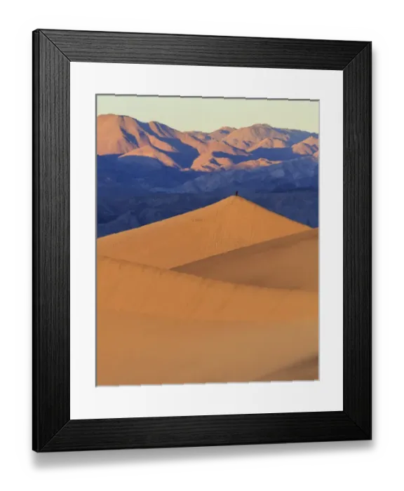 Framed Print : A photographer stands on top of a tall sand dune in sunrise light in the Mesquite Dunes