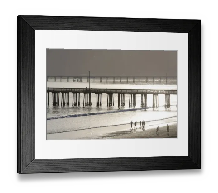 Framed Print : US, CA, Avila Beach. Silhouetted beach walkers approach pier end of day