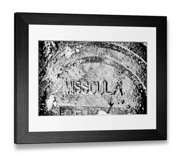 Framed Print : Rain covered manhole cover in Missoula, Montana