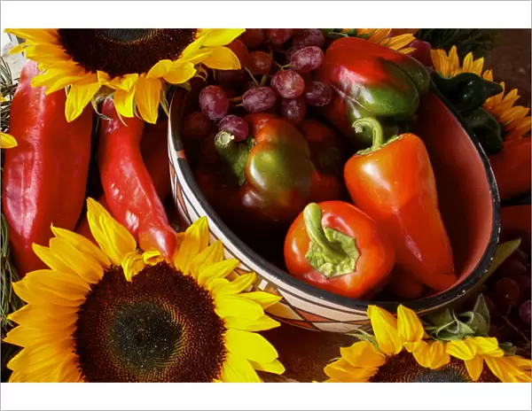 Santa Fe, New Mexico, United States. Display of red peppers and sunflowers