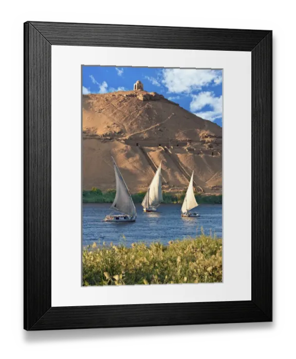Framed Print : Egypt, Aswan, Nile River, Felucca sailboats, temple ruins and the large sand dunes