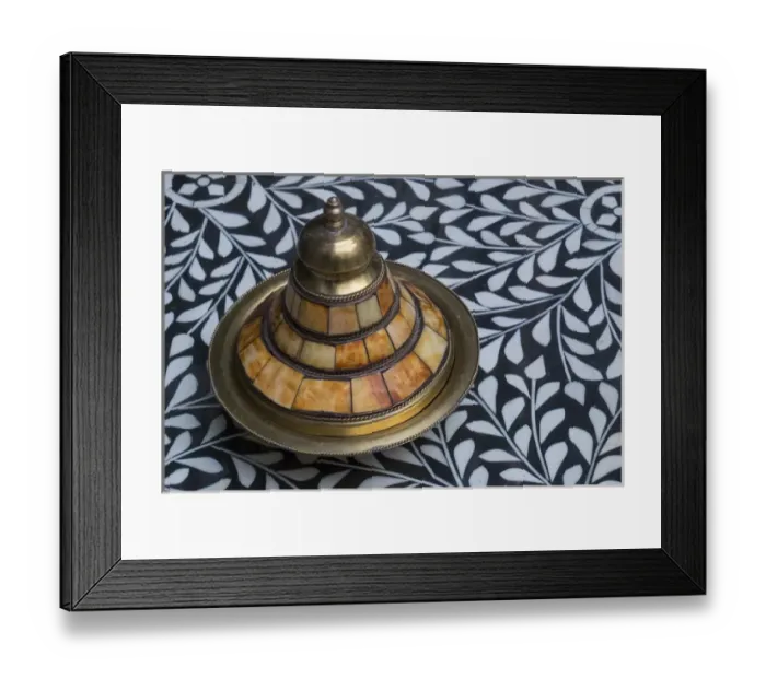 Framed Print : Africa, Morocco, Fes. A covered brass bowl with inlay of camel bone sites on a stone