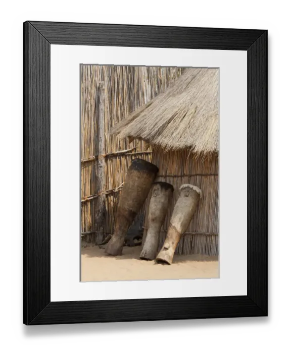 Framed Print : Africa, Namibia, Caprivi Strip. Tribal drums lean on grass hut in Mbukushu Tribe village Framed Print : Africa, Namibia, Caprivi Strip. Tribal drums lean on grass hut in Mbukushu Tribe village