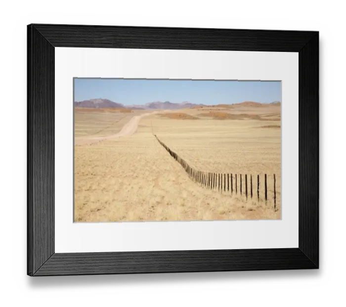 Framed Print : Africa, Namibia, Namib Desert. Long road and fence in desert Framed Print : Africa, Namibia, Namib Desert. Long road and fence in desert