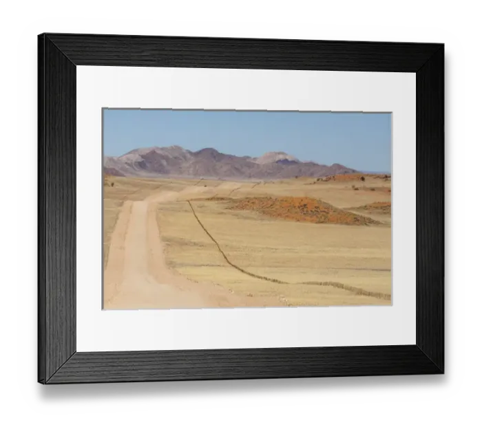 Framed Print : Africa, Namibia, Namib Desert. Long road and fence in desert Framed Print : Africa, Namibia, Namib Desert. Long road and fence in desert