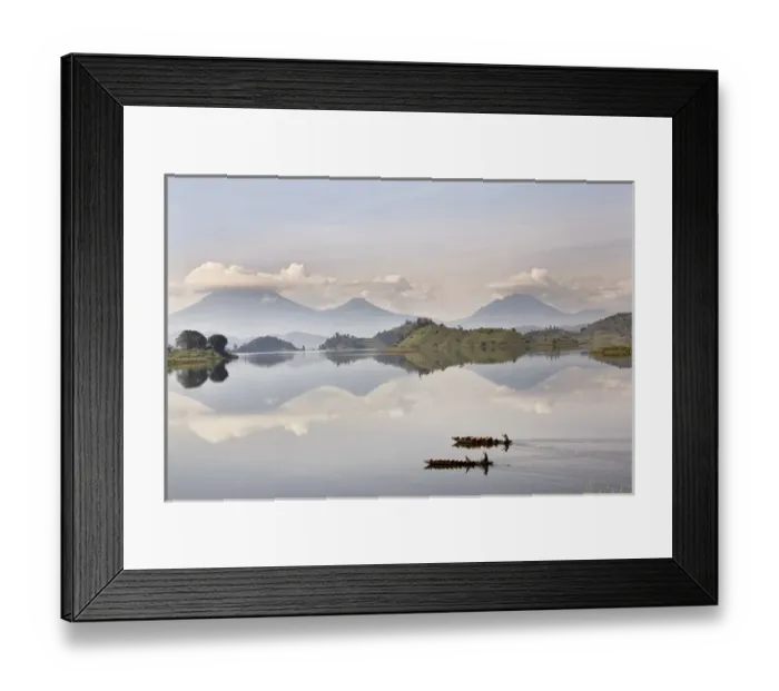 Framed Print : Dugout canoe floating on Lake Mutanda with the Virunga Vulcanoes in the background Framed Print : Dugout canoe floating on Lake Mutanda with the Virunga Vulcanoes in the background