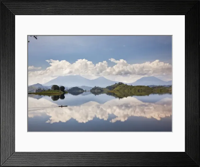 Framed Print : Dugout canoe floating on Lake Mutanda with the Virunga Vulcanoes in the background Framed Print : Dugout canoe floating on Lake Mutanda with the Virunga Vulcanoes in the background