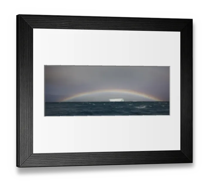 Framed Print : Antarctica, South Georgia, South Atlantic Ocean. A tabular iceberg floats under a low rainbow