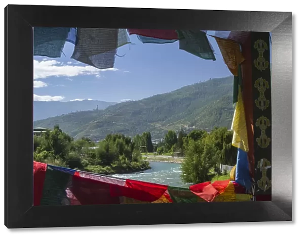 Bhutan, Punakha. Prayer flags line the cantilever bridge over the Mo Cchu river at
