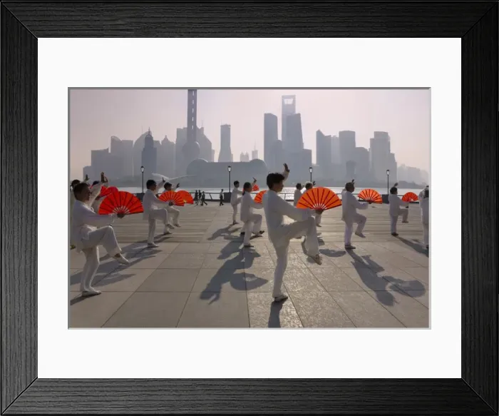 Framed Print : People practicing Taiji with red fans on the Bund in the morning, Pudong skyline Framed Print : People practicing Taiji with red fans on the Bund in the morning, Pudong skyline
