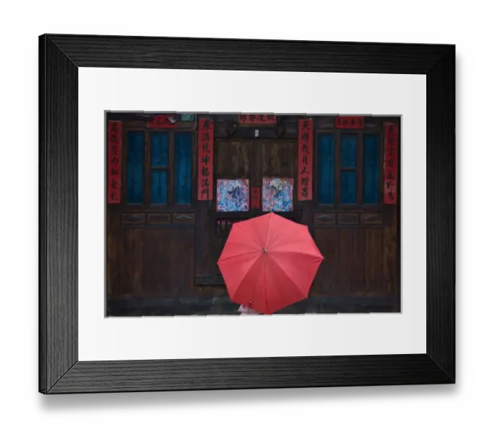 Framed Print : Girl with red umbrella watching traditional wood door decorated by poster of guarding god