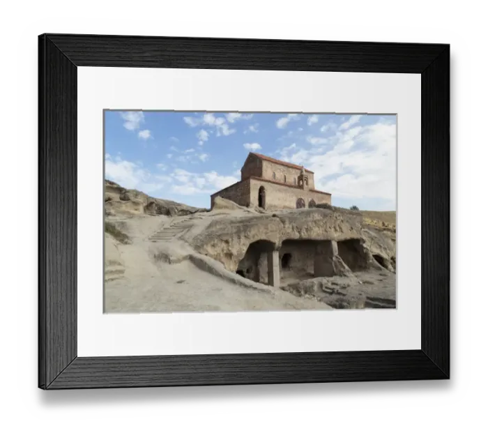 Framed Print : Georgia, Uplistsikhe. A room carved into a cliff face, with a church in the background Framed Print : Georgia, Uplistsikhe. A room carved into a cliff face, with a church in the background