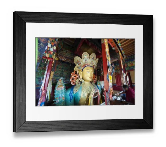 Framed Print : India, Ladakh, Thiksey, monk making offerings to golden Maitreya Buddha inside Thiksey Monastery