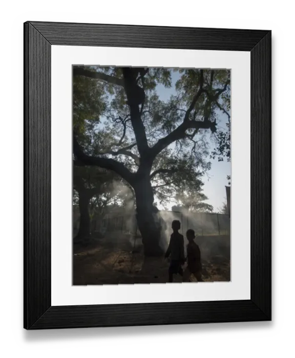 Framed Print : Pedestrians pass burning leaves in Bijapur, Karntaaka, India Framed Print : Pedestrians pass burning leaves in Bijapur, Karntaaka, India