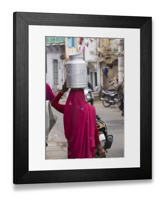 Framed Print : Asia, India, Rajasthan, Udaipur resident with container going to collect fresh goat milk Framed Print : Asia, India, Rajasthan, Udaipur resident with container going to collect fresh goat milk