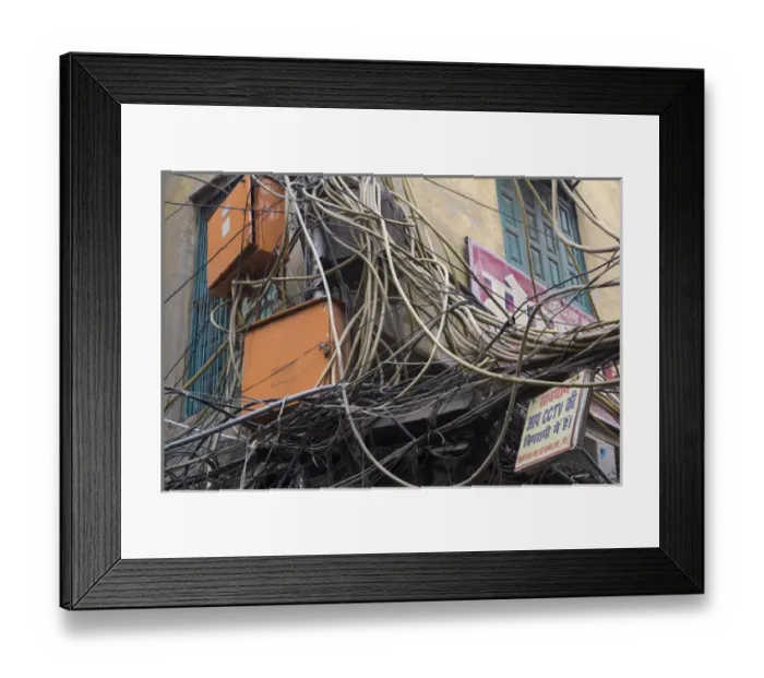 Framed Print : New Delhi, mass of wires for electronics and telecommunications strung between businesses