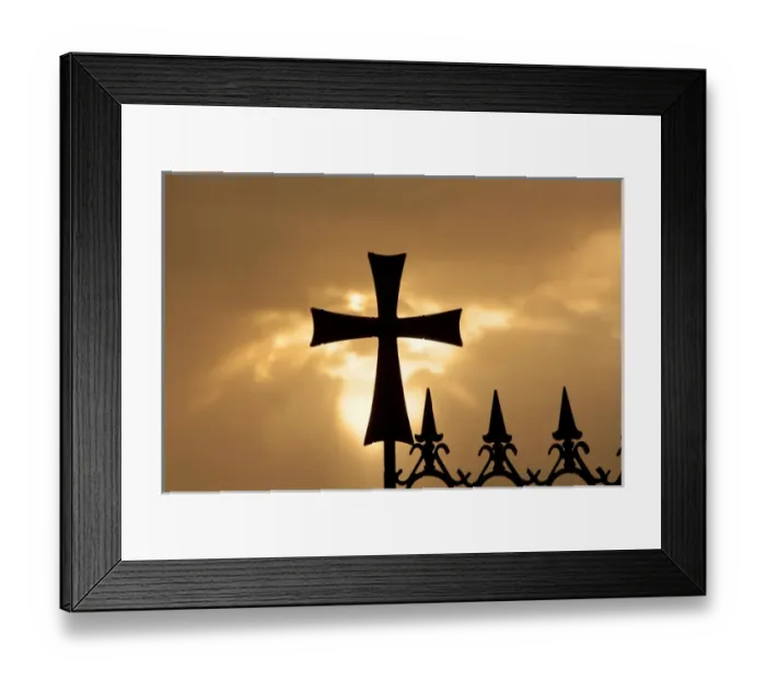 Framed Print : A wrought-iron cross on a fence in Syria at sunrise