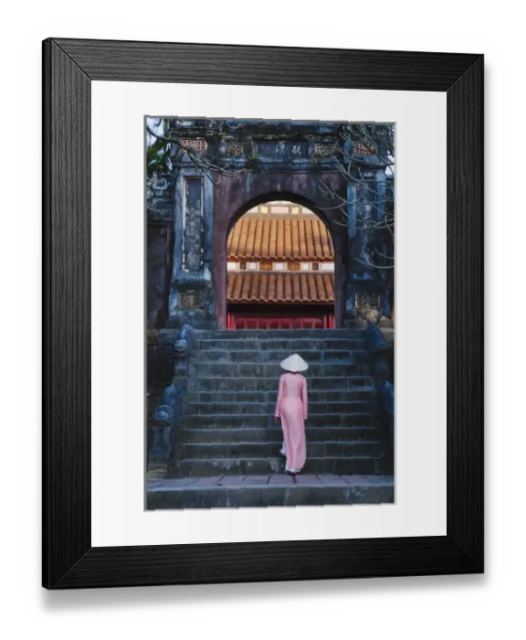 Framed Print : Girl in Ao Dai (traditional Vietnamese long dress) and conical hat at Minh Mang Tomb