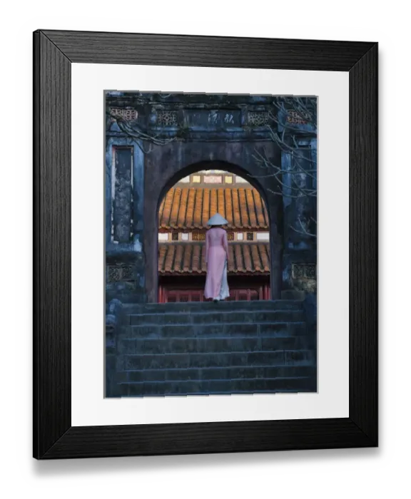 Framed Print : Girl in Ao Dai (traditional Vietnamese long dress) and conical hat at Minh Mang Tomb