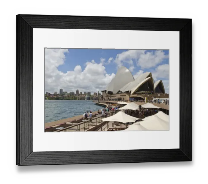 Framed Print : Closeup of restaurant umbrellas and famous Sydney Opera House in harbour in New South Framed Print : Closeup of restaurant umbrellas and famous Sydney Opera House in harbour in New South