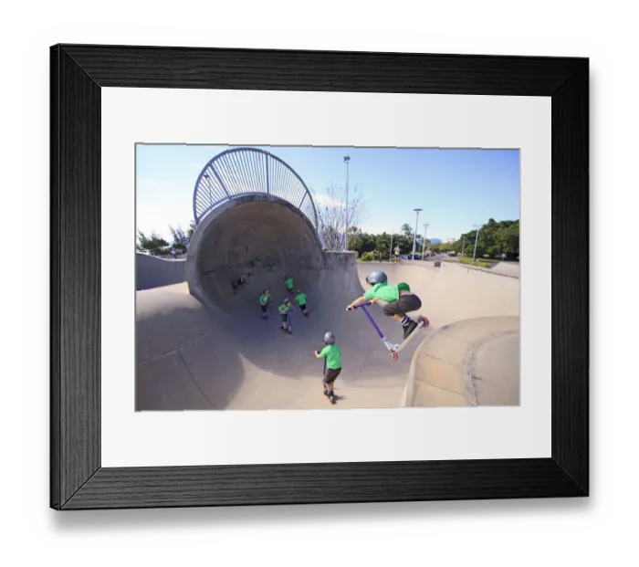 Framed Print : A young boy rides his scooter at the Esplanade Skate Park in Cairns, far north Queensland Framed Print : A young boy rides his scooter at the Esplanade Skate Park in Cairns, far north Queensland