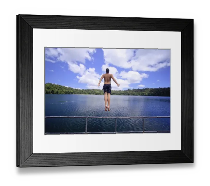 Framed Print : A young man jumps into the refreshing waters of Lake Eacham in the Crater Lakes National Park Framed Print : A young man jumps into the refreshing waters of Lake Eacham in the Crater Lakes National Park