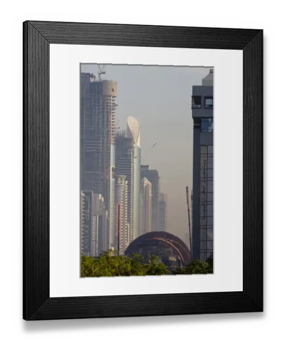 Framed Print : United Arab Emirates, Dubai. Metro station under construction, with buildings of