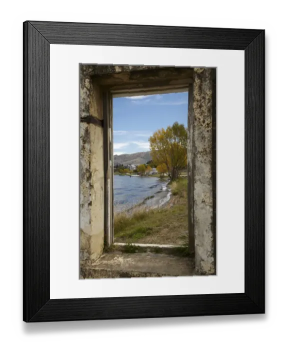 Framed Print : Looking through window of derelict building to Lake Dunstan and Old Cromwell Town