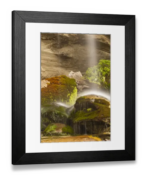 Framed Print : New Zealand, South Island, Paparoa National Park. Waterfall striking rocks at base of cliff