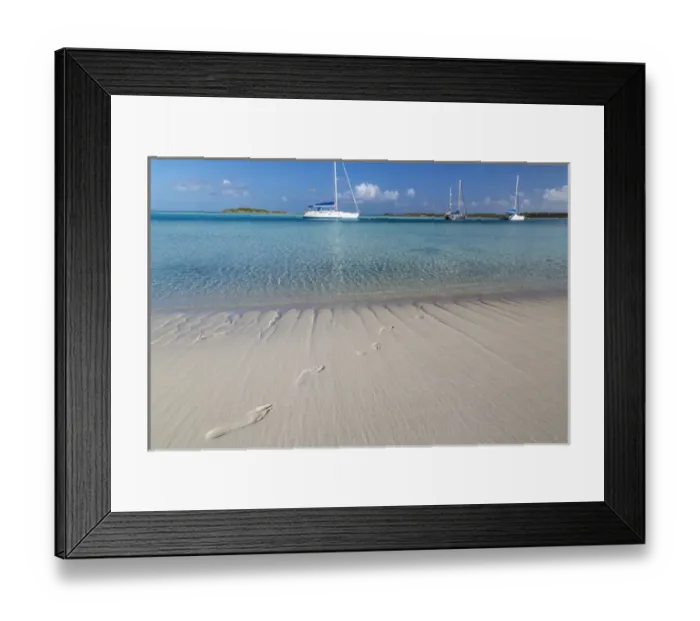 Framed Print : Bahamas, Exuma Island, Cays Land and Sea Park. Sand footprints and moored sailboats