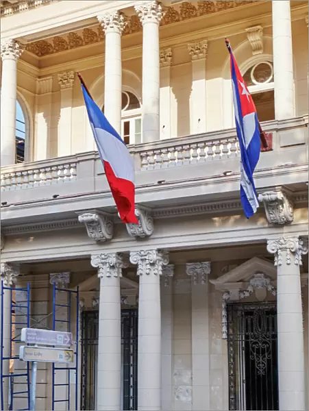 West Indies, Cuba, Havana. French and Cuban flags fly from building