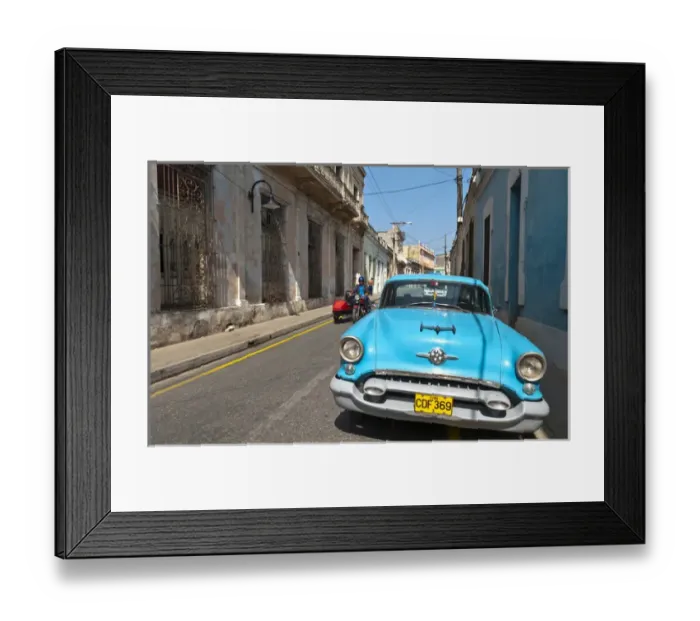 Framed Print : Camaquey Cuba street scene of old Oldsmobile car on street and buildings Framed Print : Camaquey Cuba street scene of old Oldsmobile car on street and buildings