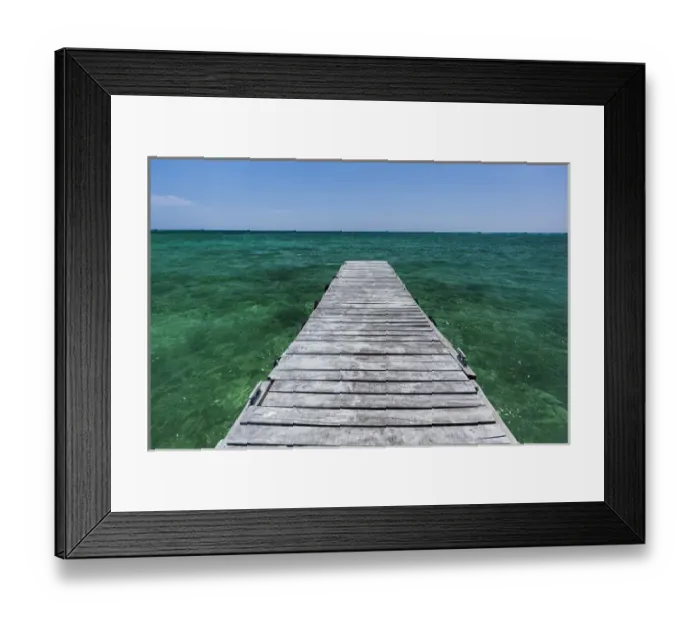 Framed Print : A wood dock in the foreground with clear green water and blue skies near the Isle of Youth